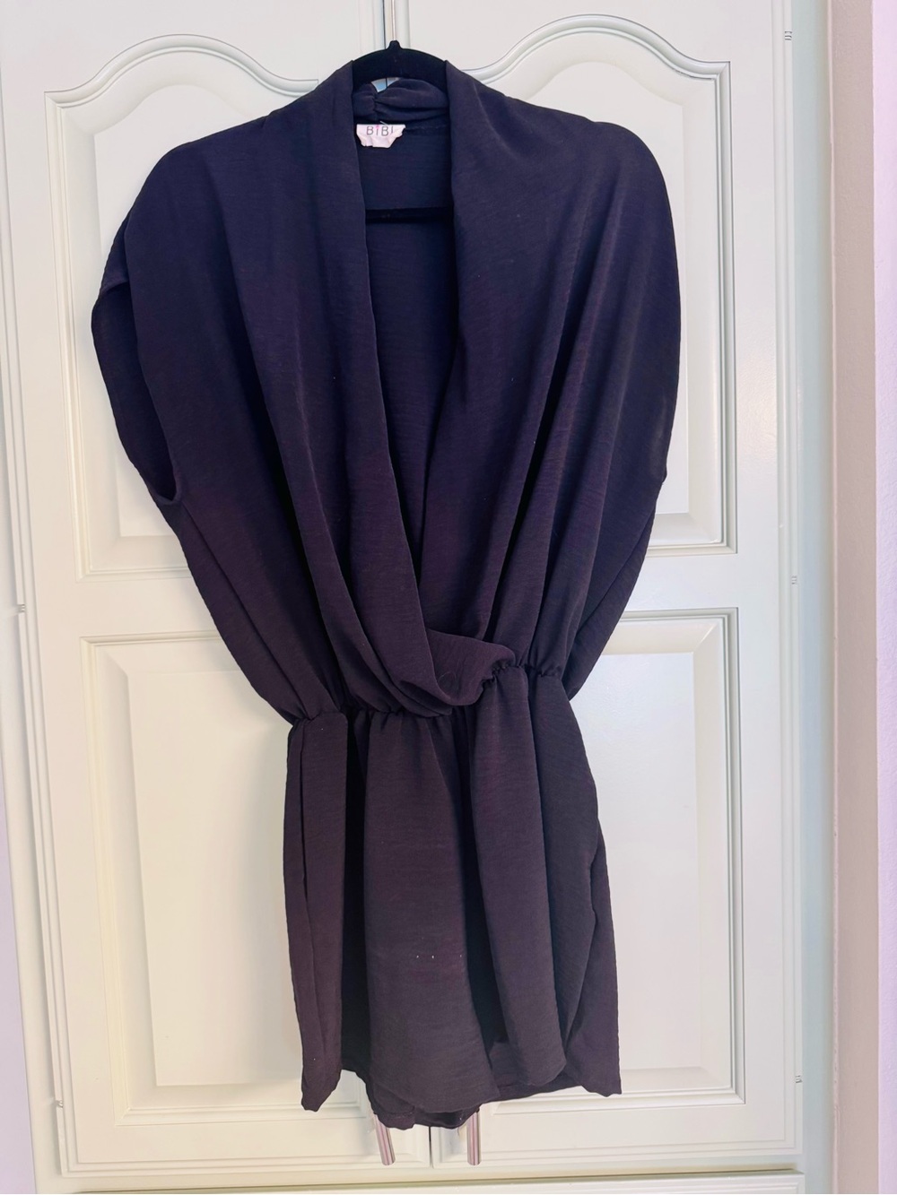 BiBi Sleeveless Wrap Romper in Black.